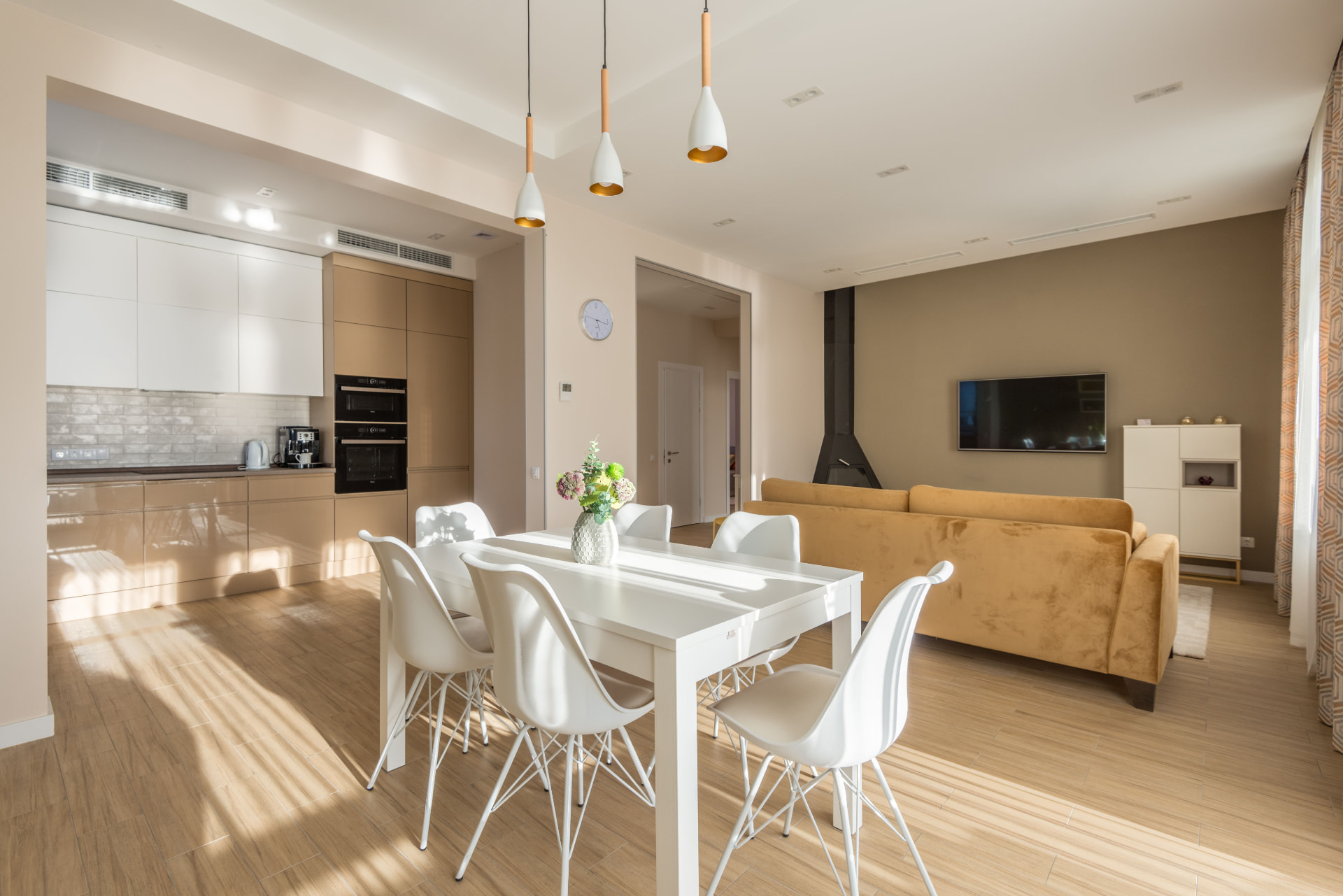 Contemporary living and dining interior with warm wood flooring